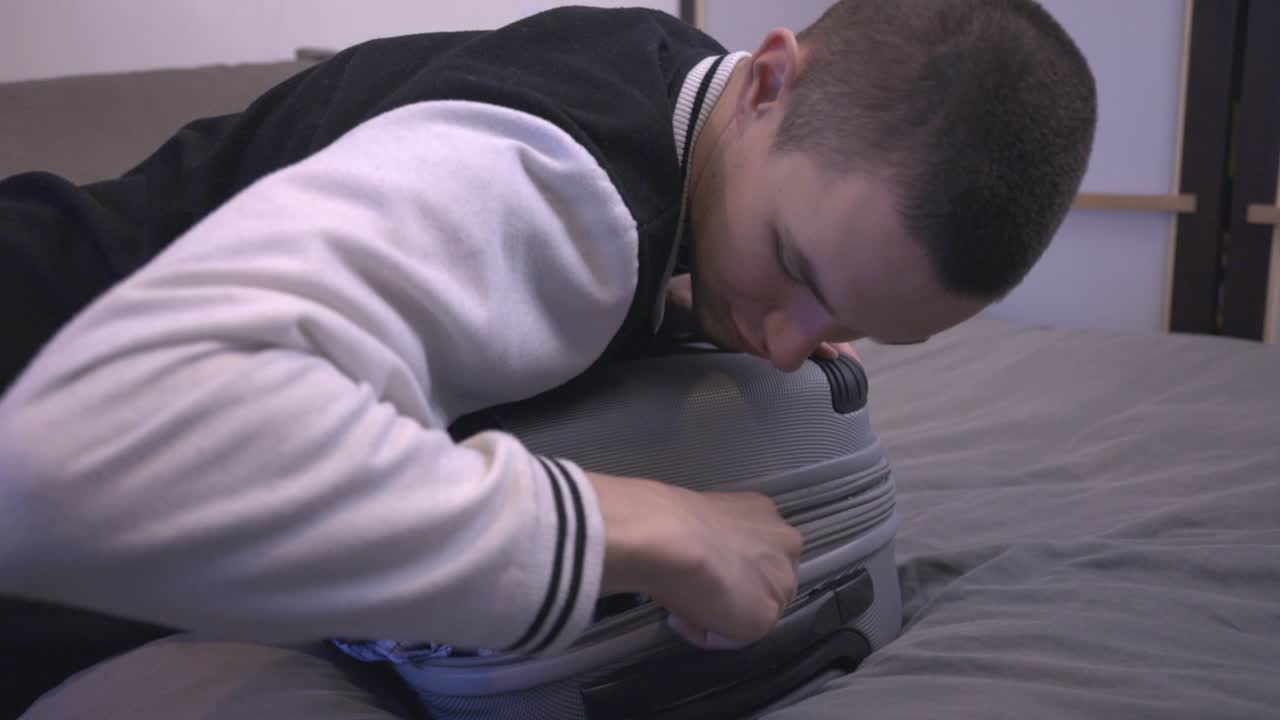 작은 가방에 옷을 포장하는 남자의 손