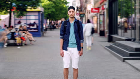 man standing on city street
