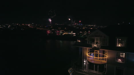 House-with-christmas-lights-and-fireworks-in-background