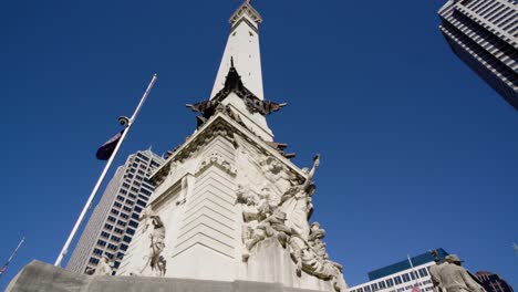 looking up at marble soldiers and sailors memorial and skyscrapers in indianapolis capitol monument circle