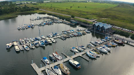 aerial shot of drone flying close to boats in marina in blotnik, pomeranian, poland