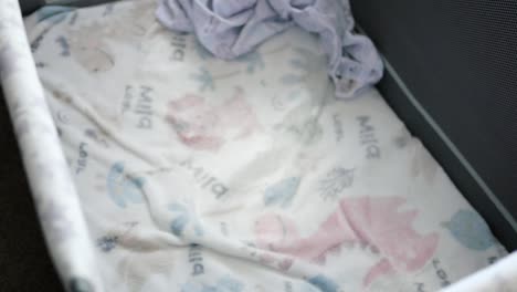 camera pans to empty baby playpen in bedroom during day