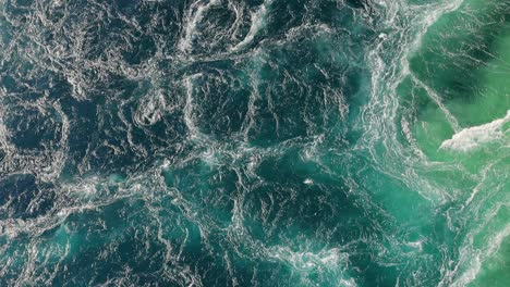blue waves of water of the river and the sea meet each other during high tide and low tide.