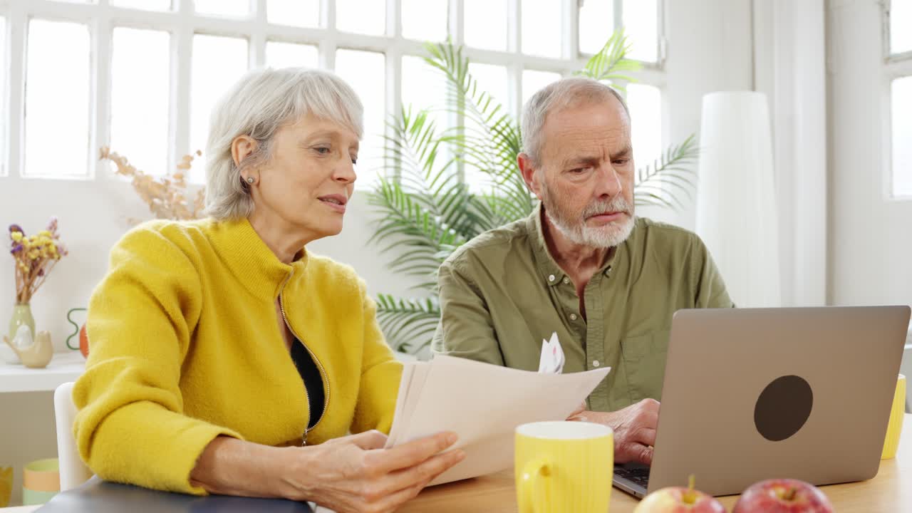 Senior couple doing finances together at home