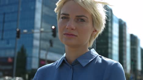 a business woman in a business district smiling at the camera