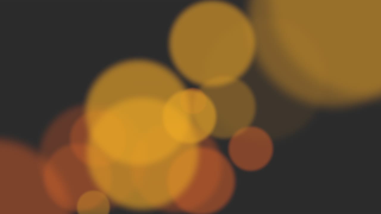 partículas grandes de color amarillo y bokeh redondo sobre un fondo oscuro
