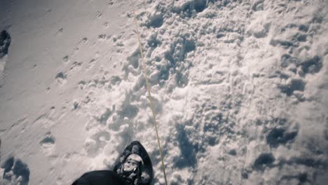 fresh snow with snowshoe prints, pov shot symbolizing winter adventure and outdoor fun.