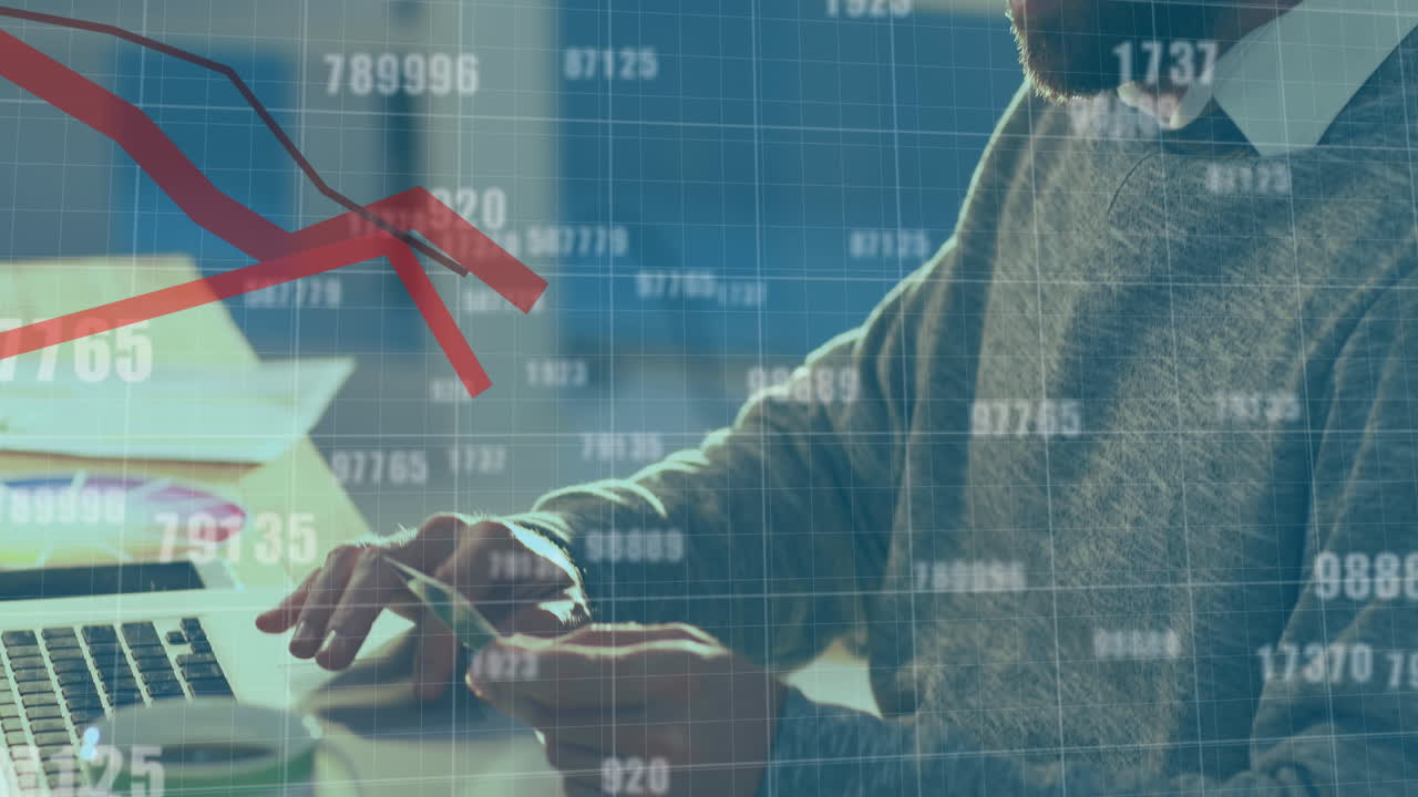 Animation of numbers changing and red lines moving over man paying online using laptop