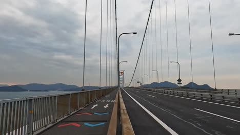 bike lane and highway on the cycle lane at kurushima kaikyo bridge, ehime, japan