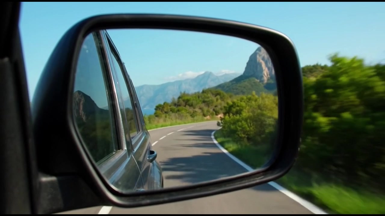 View of Coastal Road in Car Side Mirror