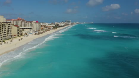 vista aérea de olas rompiendo en playas tropicales con lujosos resorts de cinco estrellas 4k