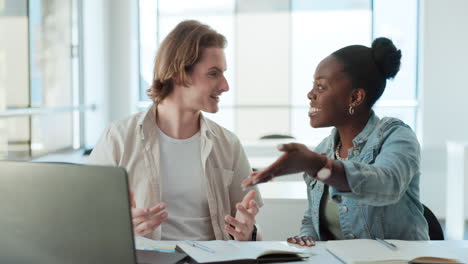 two colleagues excitedly looking at a laptop screen