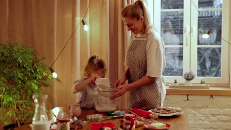 mother and daughter baking cookies together