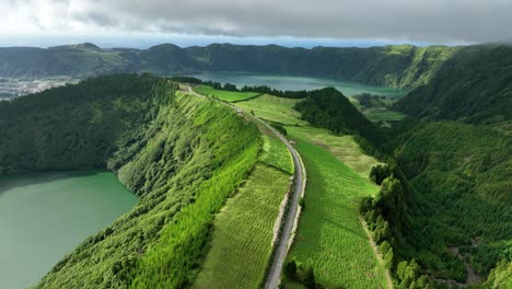 drone view over road on volcanic crater rim, sete cidades caldera, sao miguel