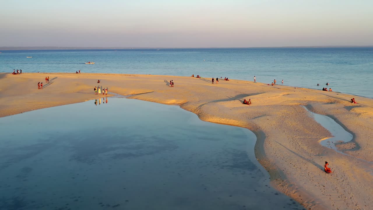 Tropical white sand beach and beautiful lagoon with people relaxing on the beautiful Boracay island