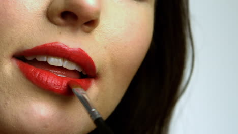 Woman-putting-red-lipstick