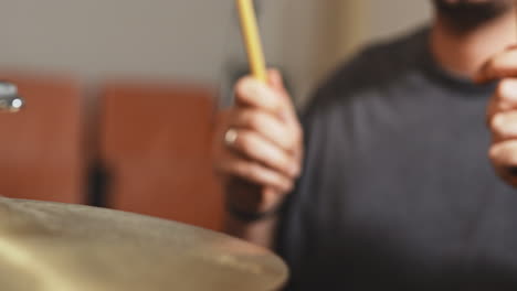 drum-stick-play-cymbal-drummer-extreme-close-up-professional-musician-in-studio