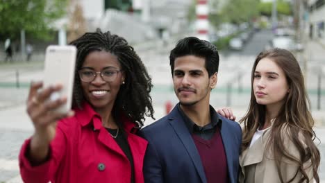 People-making-selfie-outside,-smiling,-woman-correcting-hair