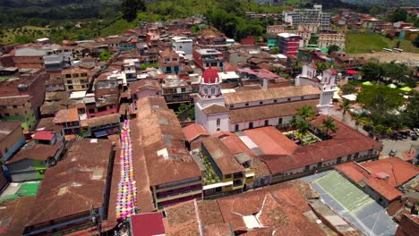 famous street and catholic cathedral of guatape picturesque village