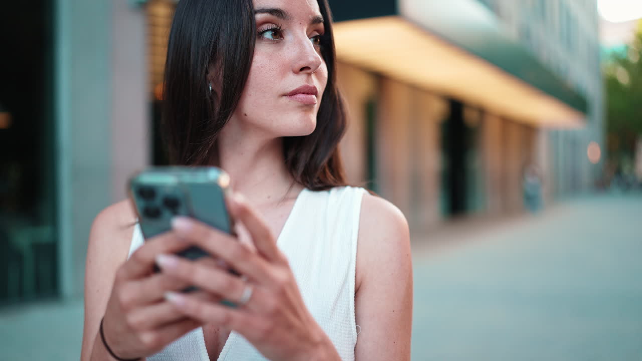 Woman using smartphone on the street