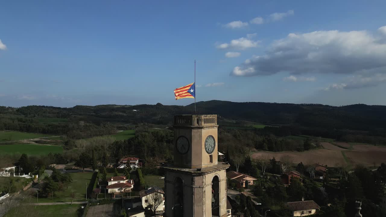 Estelada Flag at Half-Mast on Clock Tower in Catalan Village