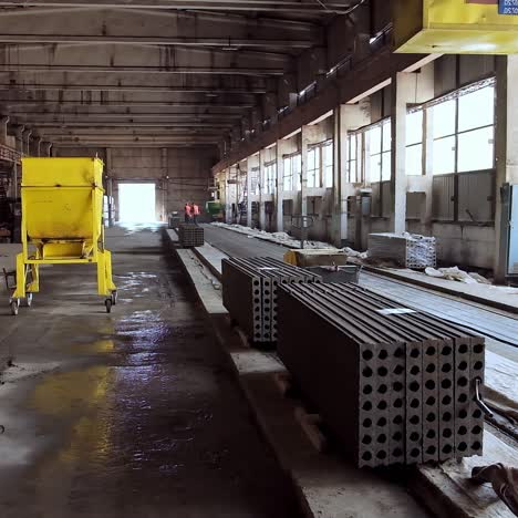 plant for production of concrete slabs indoors. reinforced concrete blocks folded in the large hangar. building materials on the factory.
