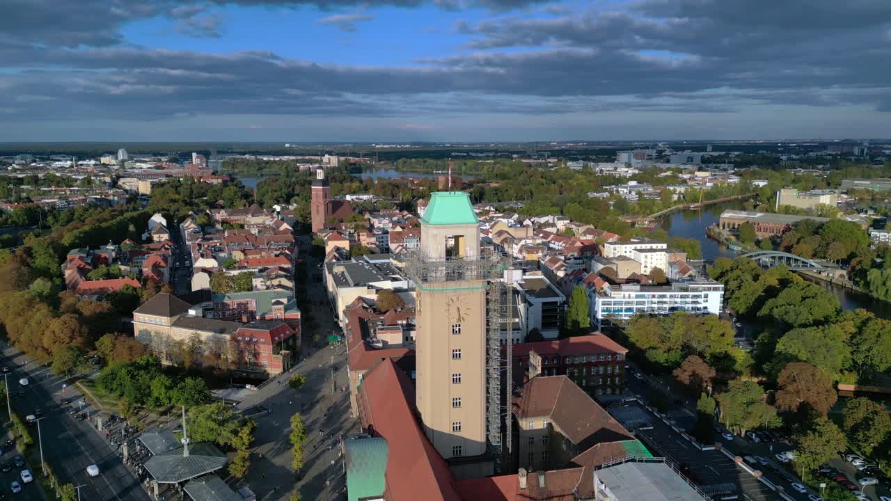 Aerial view showing Rathaus Spandau building, subway station, and public transportation in Berlin. Spectacular aerial view flight