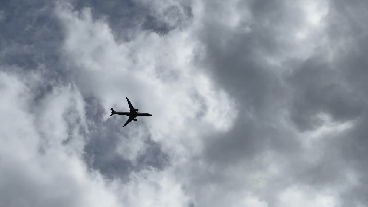 Airplane flying through cloudy sky, evokes travel and adventure