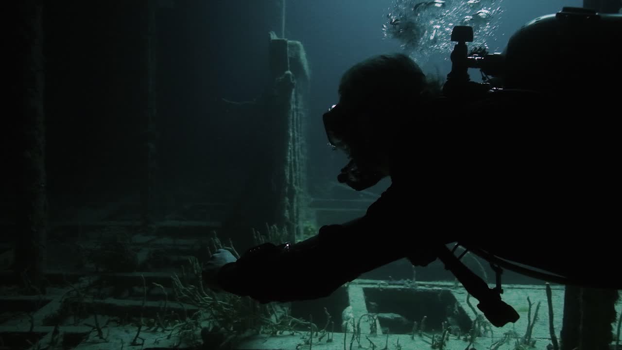 Scuba Diver swimming through the vandenberg ship wreck in florida