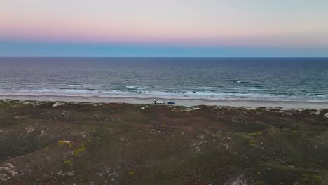 rv parked on the shore of the beach in padre island,texas,usa at sunset - aerial drone shot