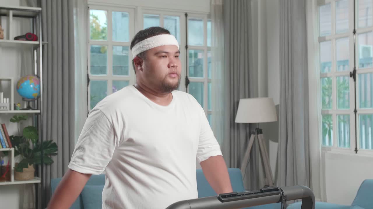 Man exercising on treadmill at home