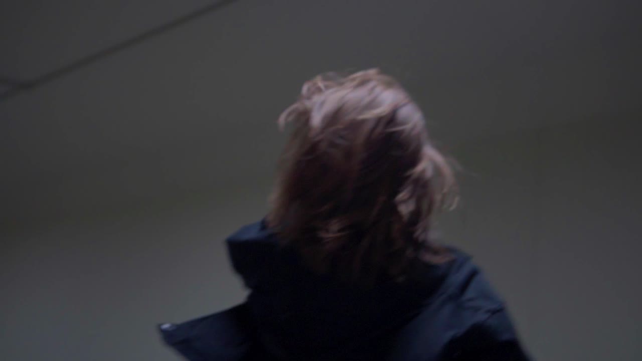 A dreamy vibe shot of a girl running slowly through an underground tunnel