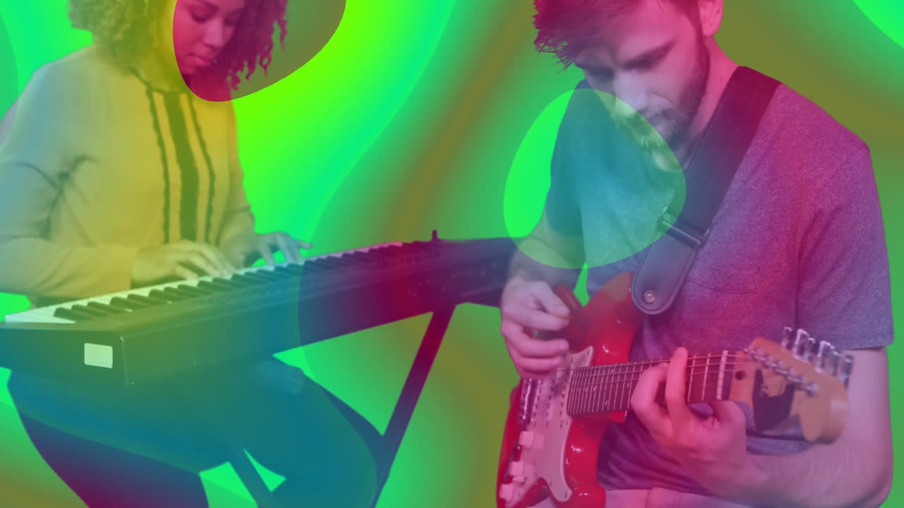 woman playing keyboard beside man playing red guitar in studio, with animated neon music notes