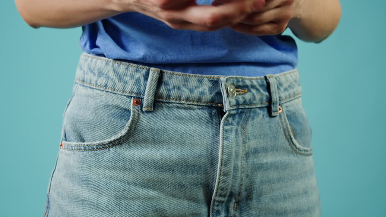 mujer poniendo algo en el bolsillo de sus vaqueros