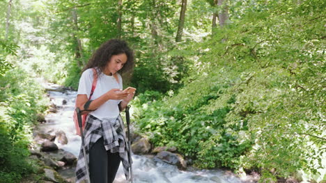 woman hiking in nature, using phone