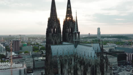 drone moves in slow-motion epic towards the cologne cathedral, it comes very close to the cologne cathedral and you can see the sunbeams shining through the towers, cinematic intro