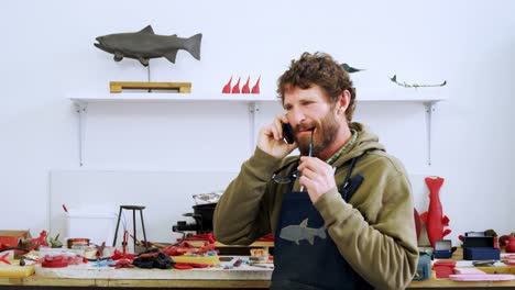 Craftsman talking on mobile phone 4k