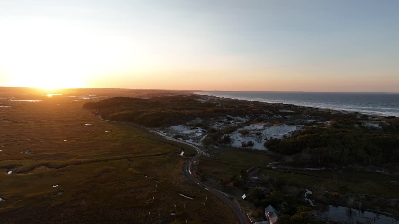 Cape cod's salt marsh and sand dunes during a peaceful sunset in massachusetts, aerial view