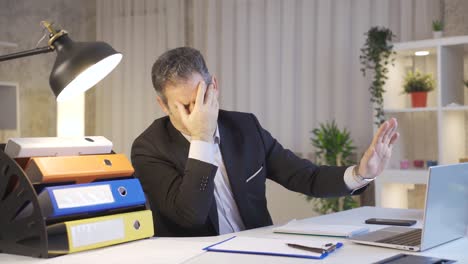 mature businessman trying not to see bad news on laptop is frustrated.