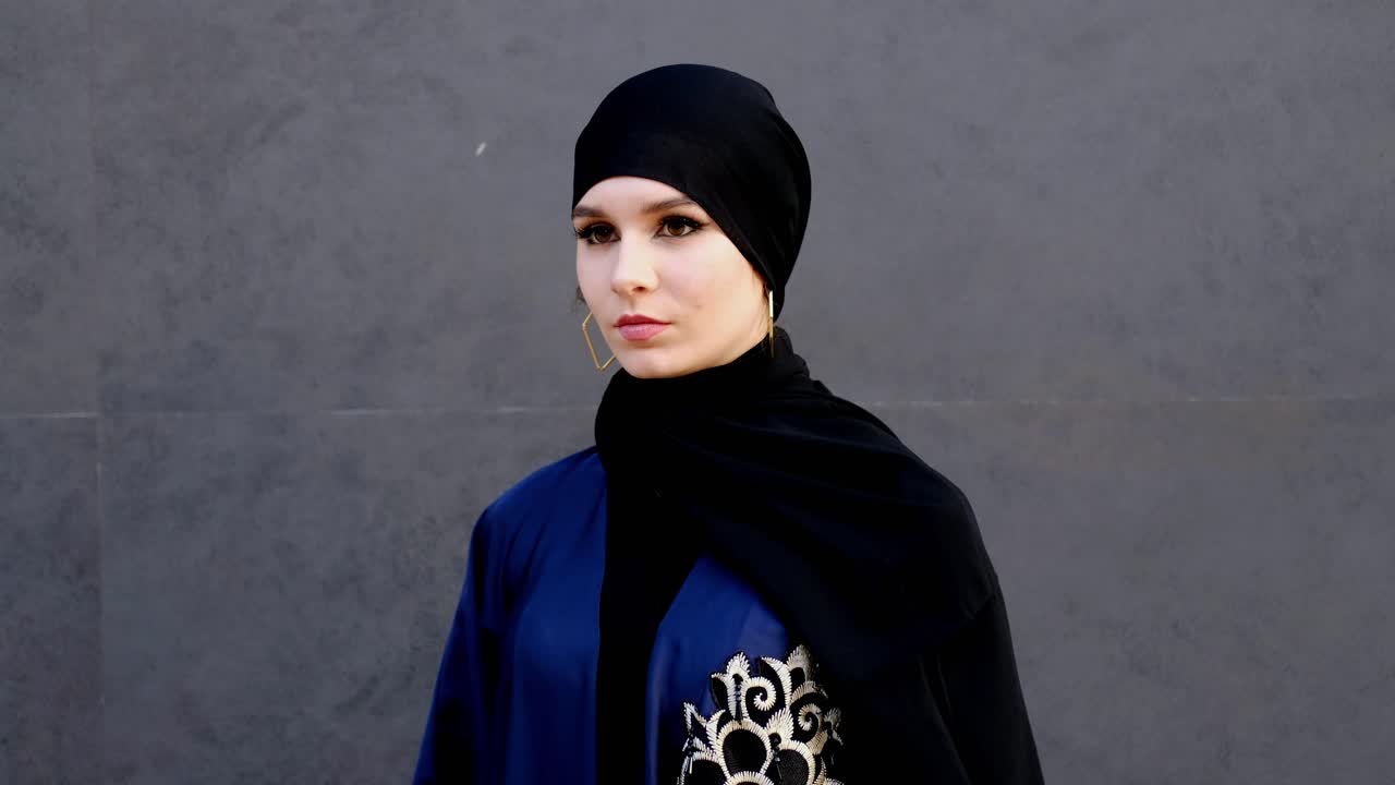 Emirati Arab woman on face mask wearing Abaya Shayla and Hijab looking at the front on white isolation background