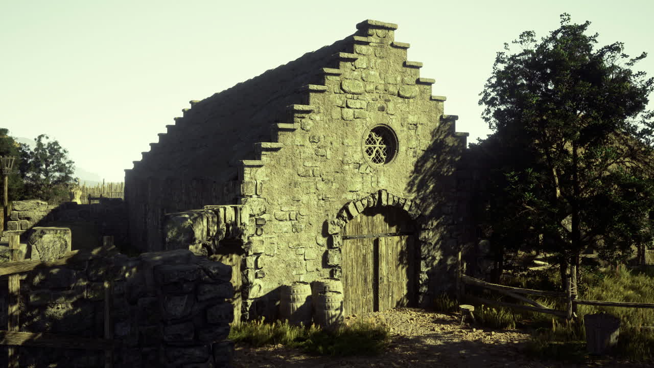 Old stone chapel in a rural landscape under clear sky
