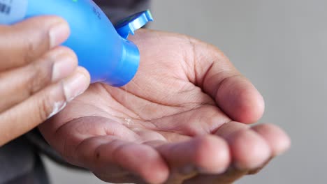 pouring hair oil on hand close up