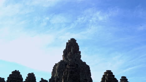 high stratus clouds, carved stone towers of ta prohm monastery, siem reap cambodia