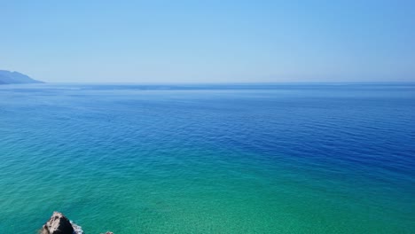 Aerial view of stunning coastline with a cliffside pool at sunrise