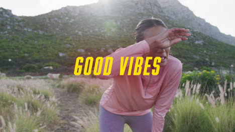 animación de las palabras buenas vibraciones escritas en amarillo sobre mujer haciendo ejercicio en las montañas tomando un descanso