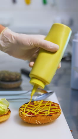process making of burger. chef making beef burgers indoor at restaurant kitchen. vertical video