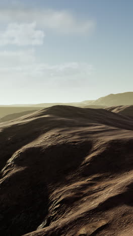 desert landscape: rolling brown hills under a bright sky