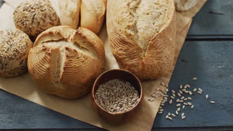 video of rolls and bread on baking paper on wooden worktop