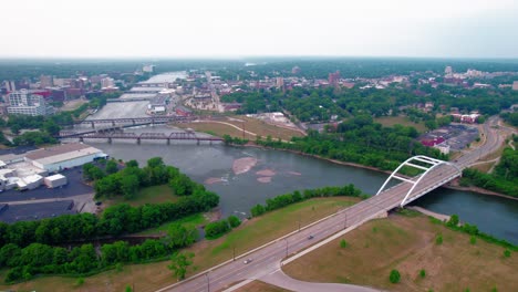 high-overview-of-Rock-River-with-many-structures:-Chestnut-Street-Bridge,-King-Bridge-Co