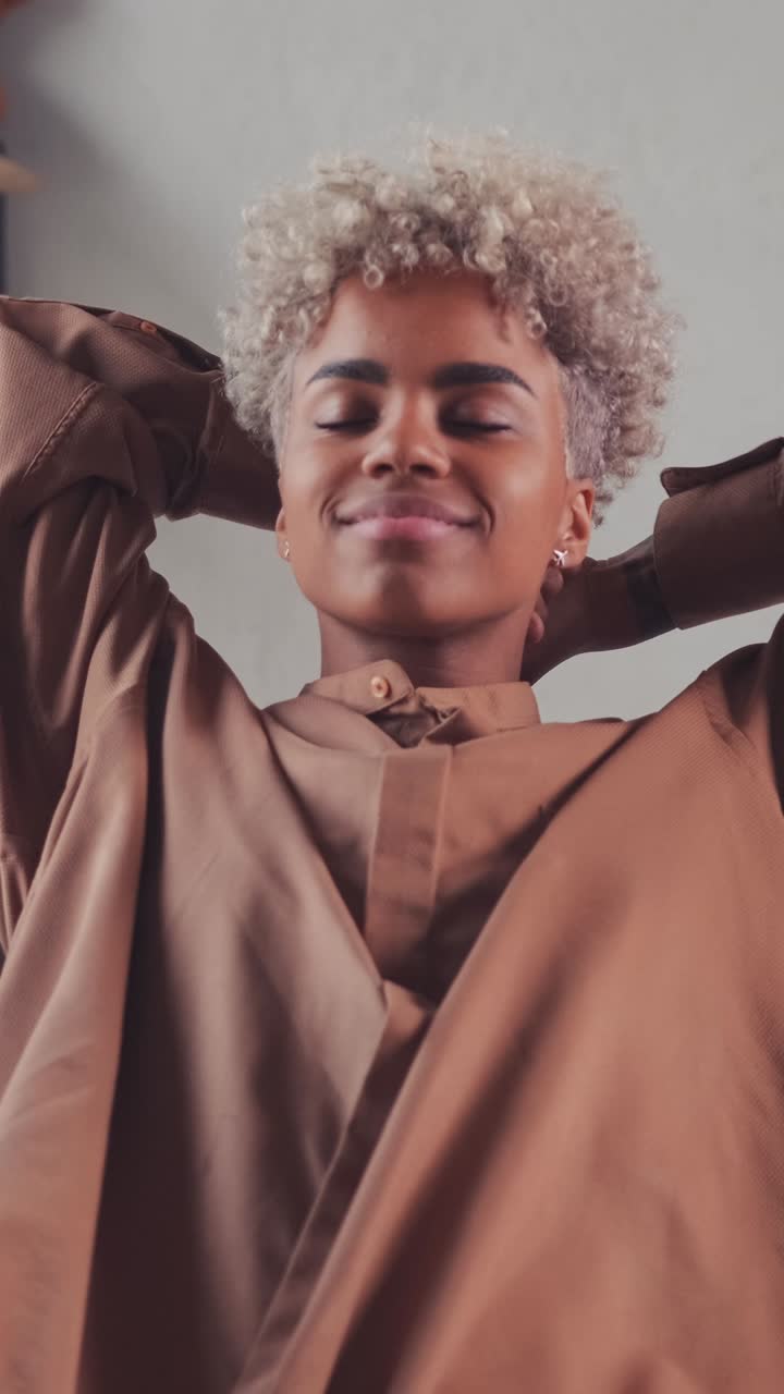 Young positive pretty african american woman pulls herself up after awakening